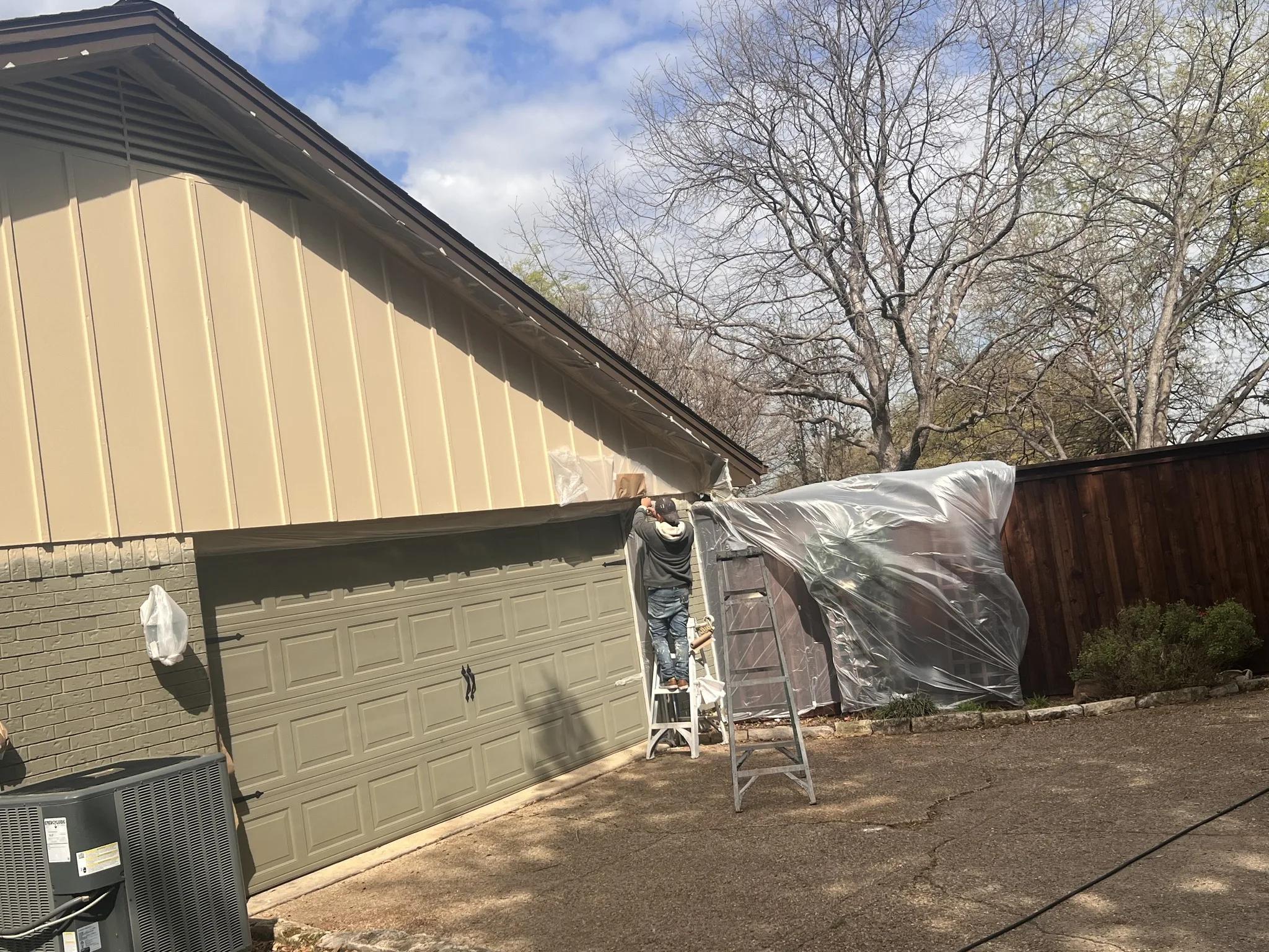 Worker painting building exterior