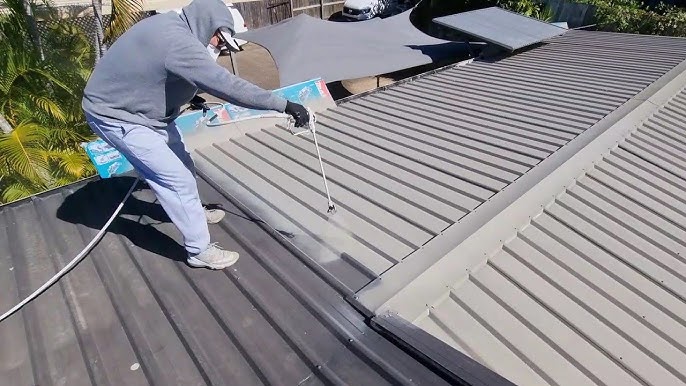 Metal roof painting with rust-inhibiting primer